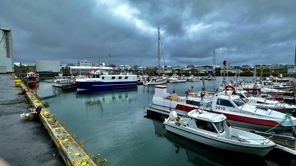 snow bear and fishing boats in arkranas harbour Iceland
