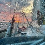 Picture of the wet sprayhood and the sunset at the north sea