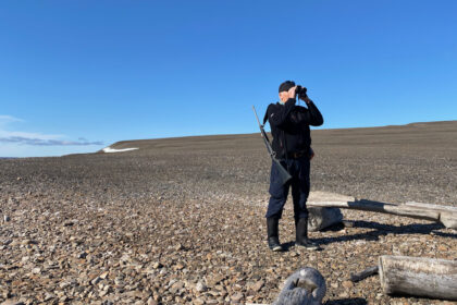 Steve scouting with binoculars