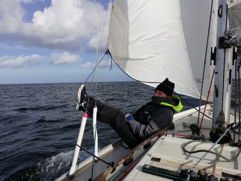 Sarah keeping out the sail with her feet