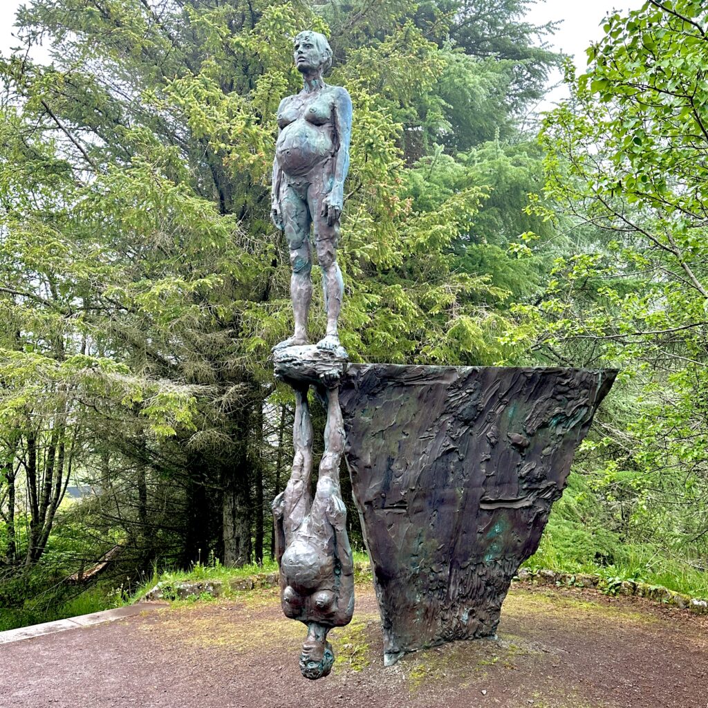 Statue of pregnant woman mirrored upside down