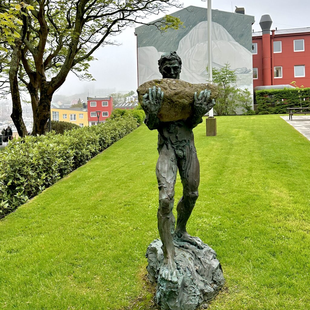 Statue of man carrying stone
